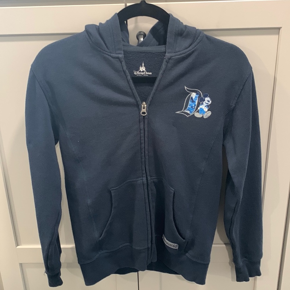 Disney Parks size large 60th anniversary zip up navy sweatshirt.  EUC